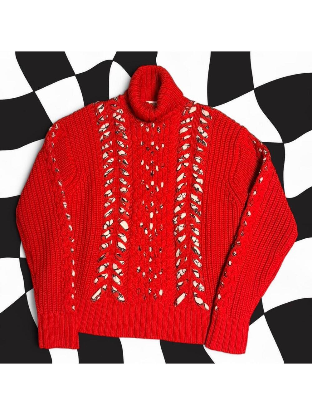 Jason Wu red cable knit sweater with openwork design.